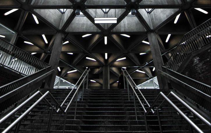 architecture-triangle-housetop Tiled glass construction in pyramid shape lit with green-violet light